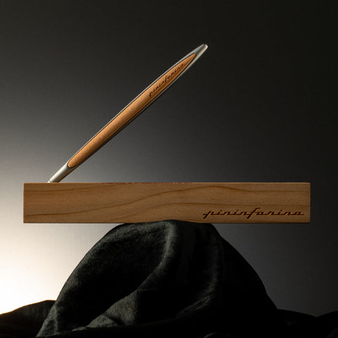 Pininfarina Segno "Cambiano Inferno Dante 700th Special Edition" luxury ethergraf inkless or ballpoint pen with aluminum body and cedar wood inserts standing in its cedar wood base with the pininfarina logo.
