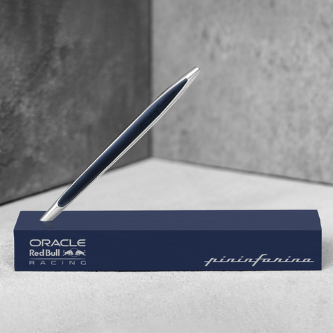 Pininfarina Segno "Cambiano Oracle Red Bull Racing" special edition pen, available in Ethergraf Inkless or ballpoint. Aluminum body with blue painted wood inserts standing in its blue base.
