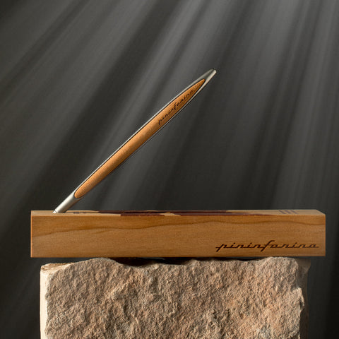 Pininfarina Segno "Cambiano Paradiso 700th edition" Ethergraf Inkless or ballpoint pen with aluminum body and walnut wood inserts standing in its walnut wood base.