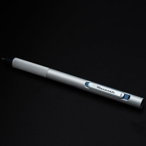 Pininfarina Segno "Slider Maserati Edition" ballpoint pen with aluminum body and blue details with the Maserati logo.