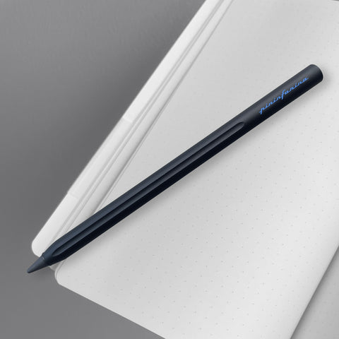 Pininfarina Segno "SMART" pencil with grafeex tip and black painted aluminum body above a stone paper dotted notebook.