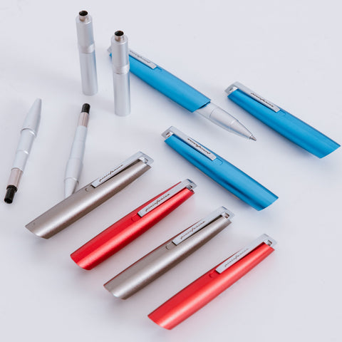 Disassembled Pininfarina Segno "PF GO Ballpoint" pens, showing their refill and components.