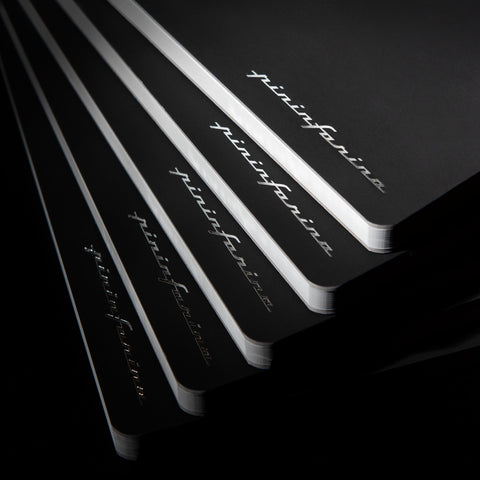 Pininfarina Segno "Stone Paper Notebooks" piled up in their black version.