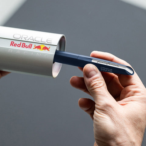 Hand taking the Pininfarina Segno "PF TWO Oracle Red Bull Racing" out of its packaging.