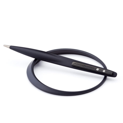 Pininfarina Segno "Space" ethergraf inkless pen with magnesium body in its black version lying in its ellipsoidal aluminum desk base.