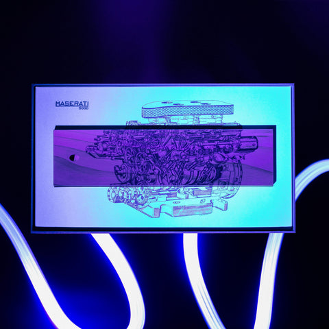 Packaging of the Pininfarina Segno "Cambiano Engine Maserati Special Edition" showing the cedar wood base with a drawing of an engine in neon lights.