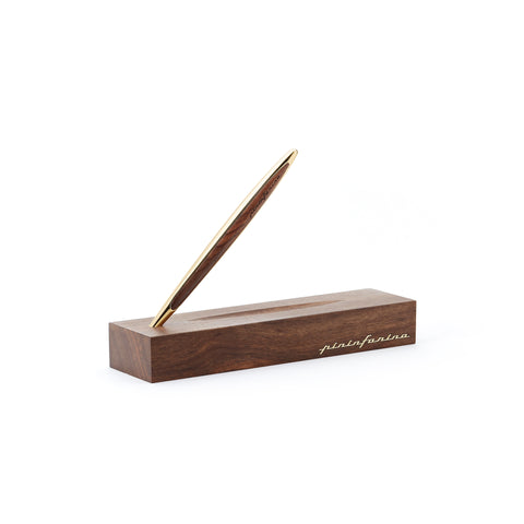 Pininfarina Segno "Cambiano Luxury" Ethergraf Inkless pen with gold plated stem and walnut wood inserts standing in its walnut wood base in white background.