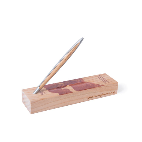 Pininfarina Segno "Cambiano Paradiso 700th edition" Ethergraf Inkless or ballpoint pen with aluminum body and walnut wood inserts standing in its walnut wood base.