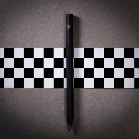 Pininfarina Segno "SMART Maserati Edition" pencil with grafeex tip and black painted aluminum body with a yellow Maserati trident in a checkered flag and concrete background.