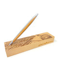 Pininfarina Segno "Cambiano Italian Beauty" Ethergraf Inkless or ballpoint pen with silver aluminum body and walnut wood inserts standing in its base with plans of different cities in Italy in a white background.