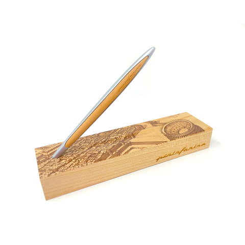Pininfarina Segno "Cambiano Italian Beauty" Ethergraf Inkless or ballpoint pen with silver aluminum body and walnut wood inserts standing in its base with plans of different cities in Italy in a white background.