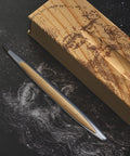 Pininfarina Segno "Cambiano Leonardo Drawing" special Leonardo Da Vinci edition in Ethergraf Inkless pen with aluminum body and walnut wood inserts next to its base that has engraved a portrait of Da Vinci in pointillism.