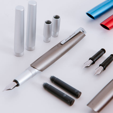 Disassembled Pininfarina Segno "PF GO Fountain Pen" pens, showing their refill and components.