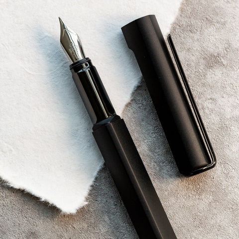Close up of the tip and cap of the Pininfarina Segno "PF ONE Fountain Pen" in its black version.
