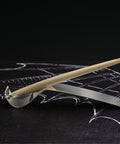 FO - Forever Made In Italy "Piuma Leonardo Special Edition" ethergraf inkless or ballpoint pen in its maple wood steam version, standing in its stainless steel ondulated base. 