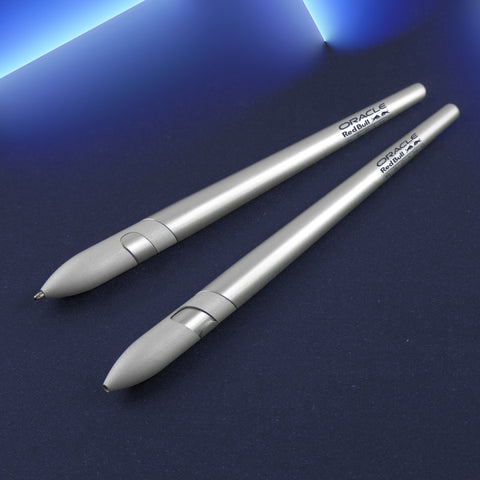 Two "Sostanza® Silver Ink Oracle Red Bull Racing" special edition ballpoint pen with aluminum body in a blue background.