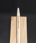 Close up of the Pininfarina Segno logo in the "Cambiano Classic" Ethergraf Inkless pen with aluminum body and cedar wood inserts and base.