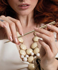 Lady holding the FO - Forever Made In Italy "Prima" Ethergraf inkless pen with anodized aluminum long body in the color Gold.
