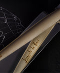FO - Forever Made In Italy "Piuma Leonardo Special Edition" ethergraf inkless or ballpoint pen in its maple wood steam version, standing in its stainless steel ondulated base, that reflects the name "Leonardo Da Vinci" engraved in the pen.