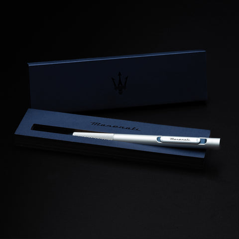 Pininfarina Segno "Slider Maserati Edition" ballpoint pen with aluminum body and blue details with the Maserati logo inside its packaging blue box.