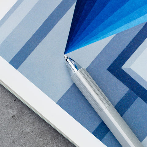 Closeup of the tip of the Pininfarina Segno "PF ONE Ballpoint" pen in its silver version with a monochromatic blue background.