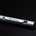 Close up of the Pininfarina Segno "Slider Maserati Edition" ballpoint pen with aluminum body and blue details with the Maserati logo.