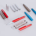 Disassembled Pininfarina Segno "PF GO Rollerball" pens, showing their refill and components.