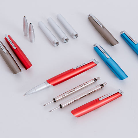 Disassembled Pininfarina Segno "PF GO Rollerball" pens, showing their refill and components.