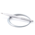 Pininfarina Segno "Space" ethergraf inkless pen with magnesium body in its pure gray version lying in its ellipsoidal aluminum desk base.