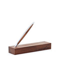 Pininfarina Segno "Cambiano Classic" Ethergraf Inkless pen with silver aluminum body and walnut wood inserts standing in its base in a white background.