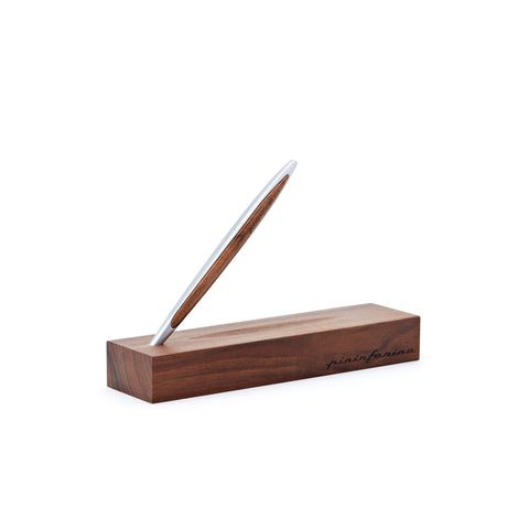 Pininfarina Segno "Cambiano Classic" Ethergraf Inkless pen with silver aluminum body and walnut wood inserts standing in its base in a white background.