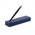 Pininfarina Segno "Cambiano Ink Blu Maserati Edition" ballpoint pen with blue aluminum body and black rubber inserts standing in its blue base with the maserati logo in a white background.
