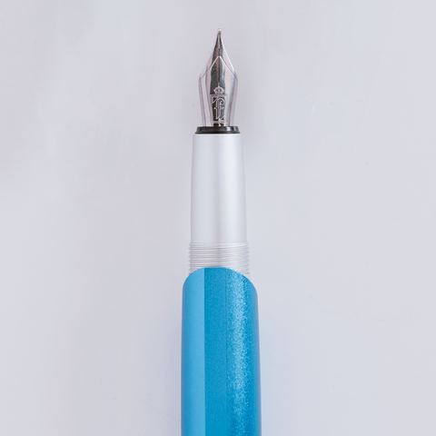 Close up of the Pininfarina Segno "PF GO Fountain Pen" tip in its blue  version. In its tip it has the Pininfarina logo engraved.