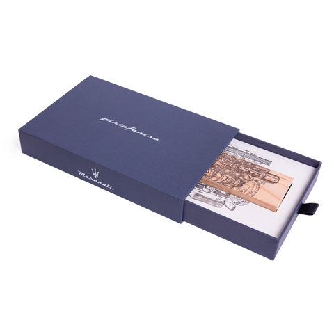 Packaging of the Pininfarina Segno "Cambiano Engine Maserati Special Edition" showing the cedar wood base with a drawing of an engine in white background.