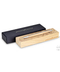 Pininfarina Segno "Cambiano Leonardo Drawing" special Leonardo Da Vinci edition. Ethergraf Inkless pen with aluminum body and walnut wood inserts, lying in its base, that has engraved a portrait of Da Vinci in pointillism, next to its packaging box.