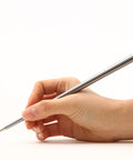 Hand holding the FO - Forever Made In Italy "Prima" Ethergraf inkless pen with anodized aluminum long body in the color Silver in white background.