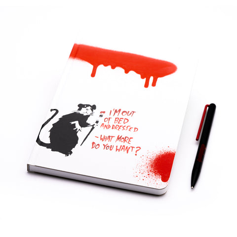 Pininfarina Segno special edition "Banksy's Graffiti Notebook" in its version "Out of Bed Rat." with a Black rat holding a brush in white background and red sprays of paint, next to a text: "I'm out of bed and dressed" - What more do you want?". Set includes a notebook and a ballpoint pen with red details.