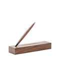 Pininfarina Segno "Cambiano Classic" Ethergraf Inkless pen with glossy black aluminum body and walnut wood inserts standing in its base in a white background.