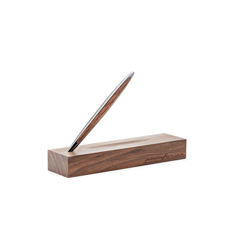 Pininfarina Segno "Cambiano Classic" Ethergraf Inkless pen with glossy black aluminum body and walnut wood inserts standing in its base in a white background.