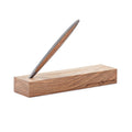 Pininfarina Segno "Cambiano Classic" Ethergraf Inkless pen with silver matt black aluminum body and walnut wood inserts standing in its base in a white background.