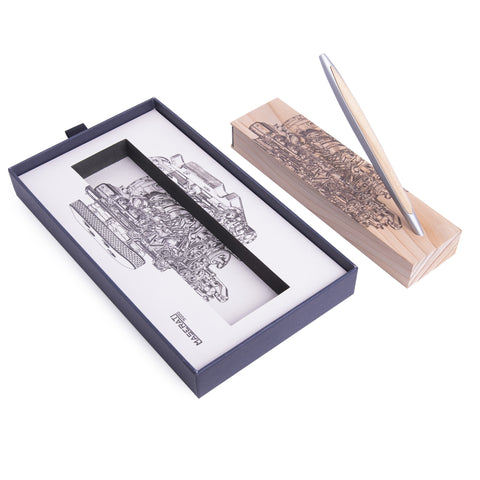 Pininfarina Segno "Cambiano Engine Maserati Special Edition" luxury ethergraf inkless pen with aluminum body and cedar wood inserts standing in its cedar wood base with a drawing of an engine, alongside its packaging box.