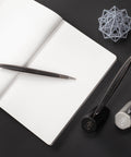 Pininfarina Cambiano Transitions Collection in both silver and black versions on their stands in a desk with a Notebook on the side