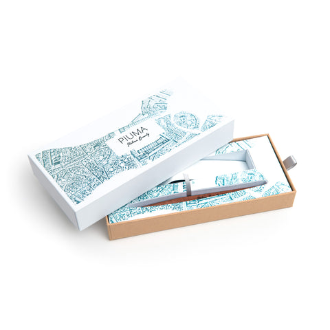 Packaging box of the FO - Forever Made In Italy "Piuma Italian Beauty" Pen with pear wood steam in the version "Venezia", along its stainless steel ondulated base. The box contains plans drawings of the city of Venice.